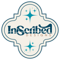 A decorative logo or emblem reading 'InScribed DESIGNS' in dark blue script inside an ornate cream quatrefoil-style frame with teal starburst accents and a thin dark blue border.