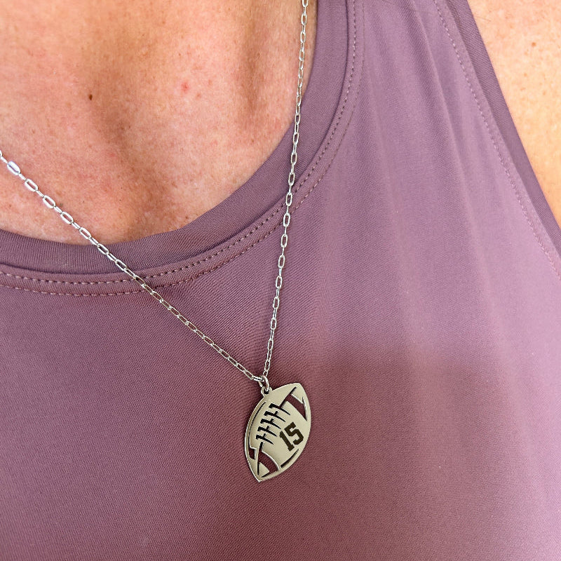 Silver stainless steel engraved necklace being worn.