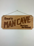 Dad's man cave sign carved out of wood and hanging on a wall.